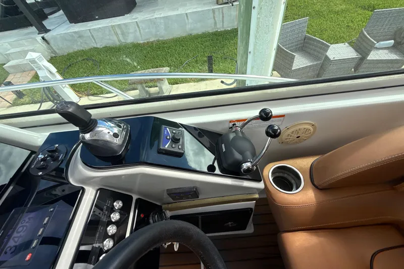 Slide: The Image of Control panel of a 2009 Formula 40 Performance Cruiser with steering wheel and navigation instruments. - 18