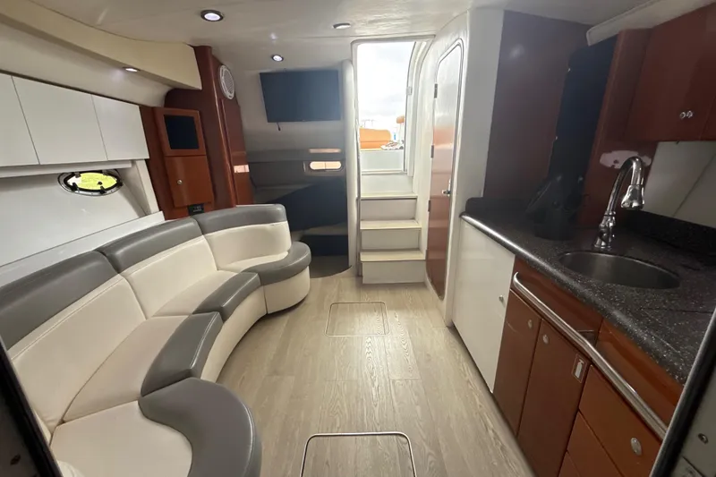 Slide: The Image of 2009 Formula 40 Performance Cruiser with tan seating, docked by a scenic waterfront. - 31