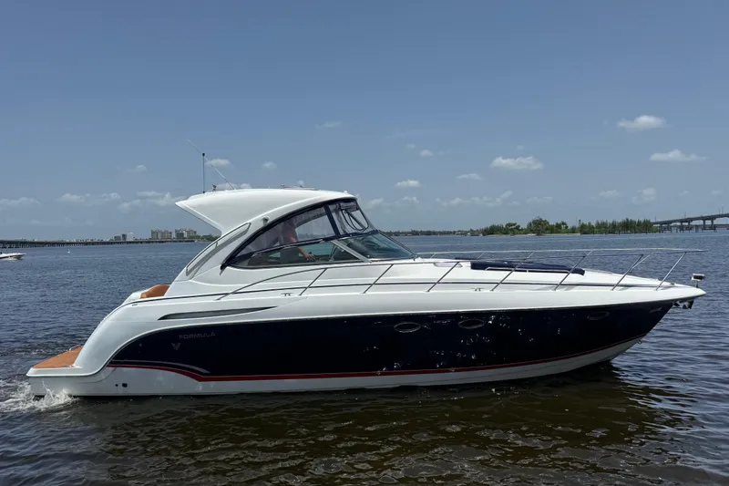 The Image of 2009 Formula 37 Performance Cruiser on calm water under clear sky. - 0