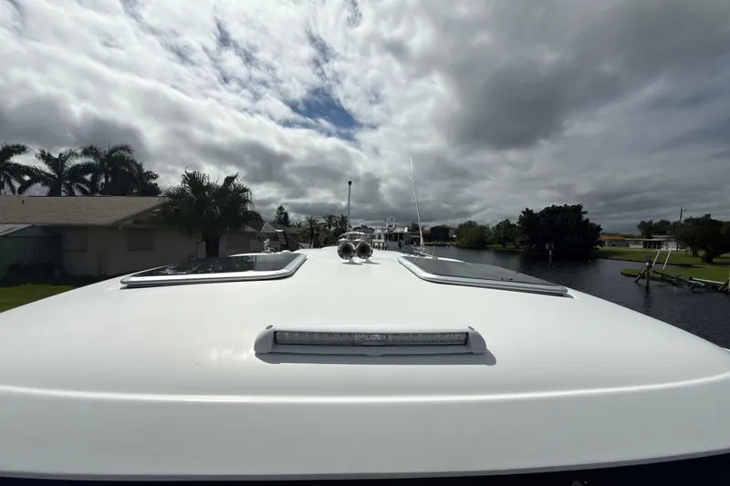 Slide: The Image of 2009 Formula 40 Performance Cruiser docked by a scenic canal under cloudy skies. - 61