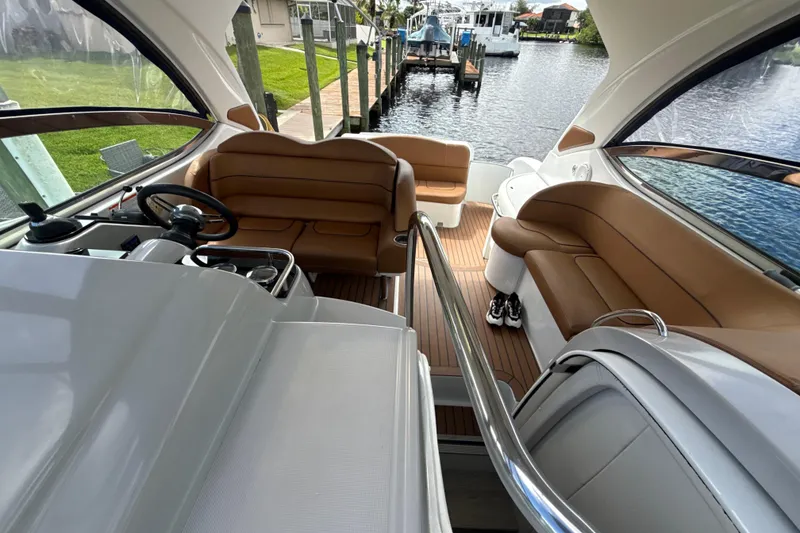 Slide: The Image of 2009 Formula 40 Performance Cruiser boat deck with blue cushions, docked by a canal. - 69