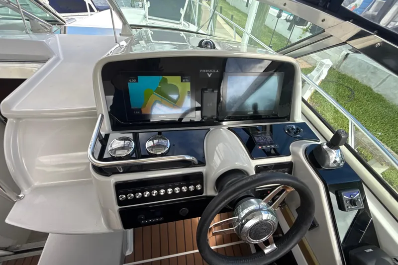 Slide: The Image of 2009 Formula 40 Performance Cruiser interior with tan seating and sleek design by the water. - 70