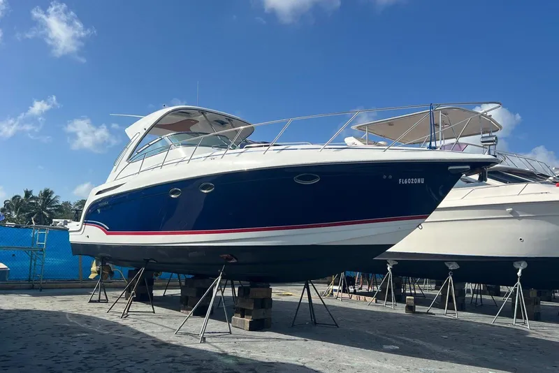 Slide: The Image of 2009 Formula 40 Performance Cruiser with tan seating, docked by a scenic waterfront. - 72