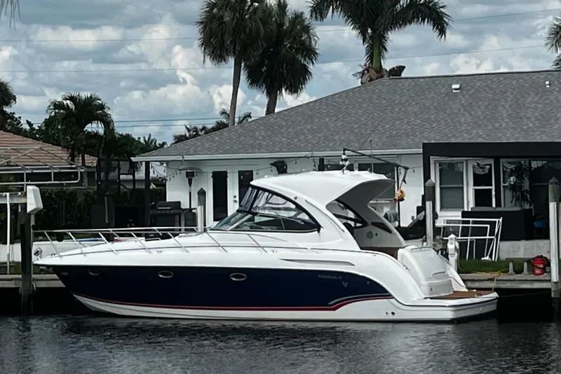 Slide: The Image of 2009 Formula 37 Performance Cruiser docked by a waterfront home with palm trees. - 75