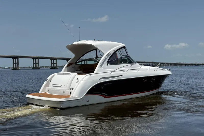 Slide: The Image of 2009 Formula 37 Performance Cruiser on water near a bridge under clear sky. - 1