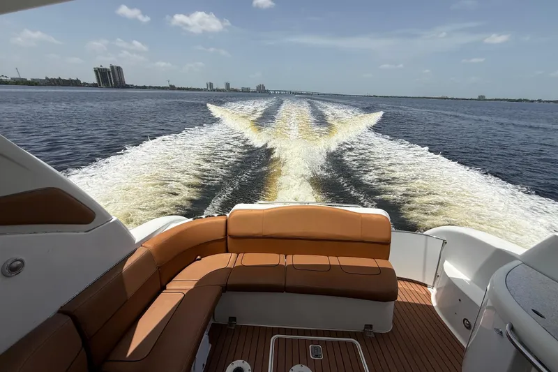 Slide: The Image of 2009 Formula 37 Performance Cruiser on water, leaving a wake under a clear sky. - 78