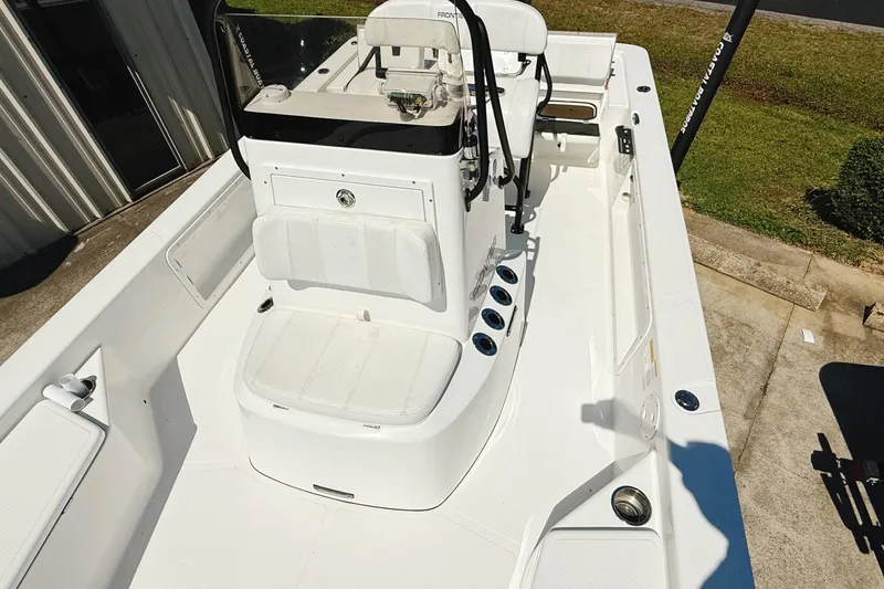 Slide: The Image of 2023 Frontier 2104 boat with Yamaha outboard motor, parked on a trailer. - 14