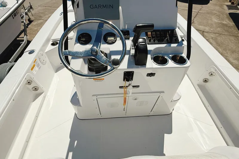 Slide: The Image of 2023 Frontier 2104 boat on trailer under clear blue sky. - 16