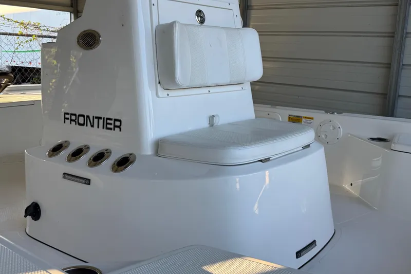 Slide: The Image of 2023 Frontier 2104 boat interior with white seating and black frame. - 23
