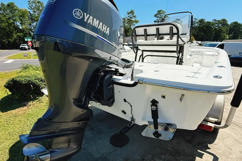 Slide: The Image of 2023 Frontier 2104 boat interior with white seating and console. - 24