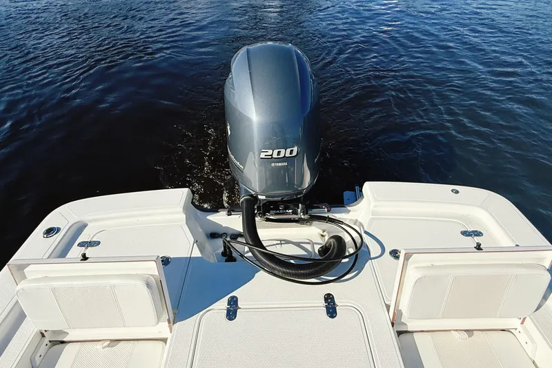 Slide: The Image of 2023 Frontier 2104 boat on calm water with Yamaha outboard motor. - 29
