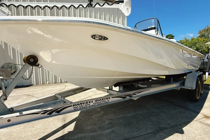 Slide: The Image of 2023 Frontier 2104 boat on water near shoreline with trees. - 3