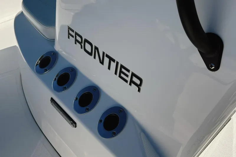 Slide: The Image of ```json { "alt_text": "Frontier 2104 boat with marine radio on deck, 2023 model." } ``` - 32