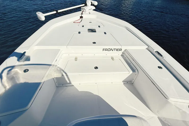 Slide: The Image of 2023 Frontier 2104 boat console with rod holders and sleek design. - 33