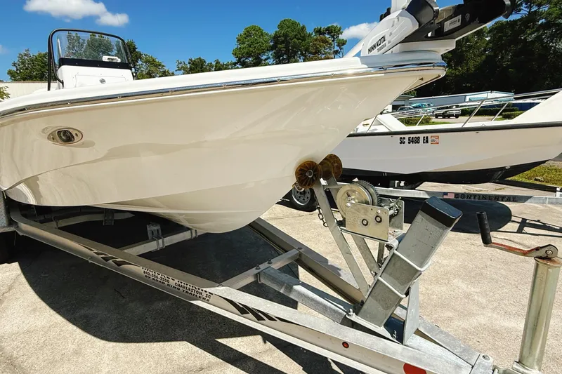 Slide: The Image of 2023 Frontier 2104 boat console with steering wheel, Garmin system, and cup holders. - 4