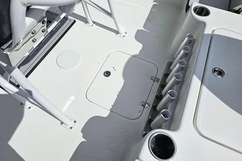 Slide: The Image of 2026 Sea Pro 210 Bay boat deck with rod holders and storage compartments. - 13