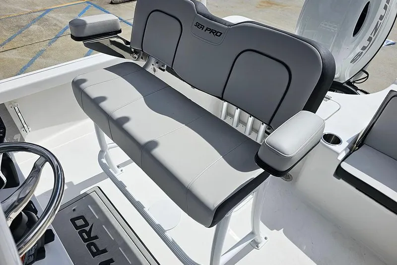 Slide: The Image of 2026 Sea Pro 210 Bay boat interior with gray seating and steering wheel. - 15