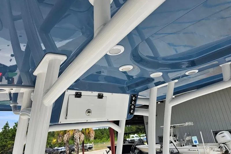 Slide: The Image of 2026 Sea Pro 210 Bay boat with blue T-top and white supports. - 17