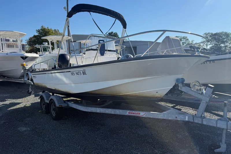 The Image of 2014 Boston Whaler 190 Montauk boat on trailer in a marina. - 0