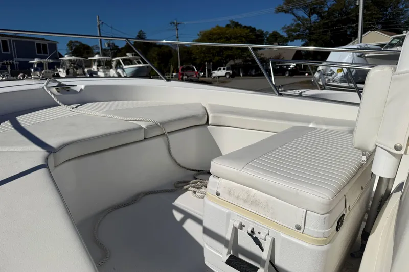 Slide: The Image of 2014 Boston Whaler 190 Montauk boat interior with white seating and railing. - 4