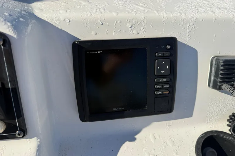Slide: The Image of Garmin device on 2014 Boston Whaler 190 Montauk boat dashboard, with water droplets. - 7