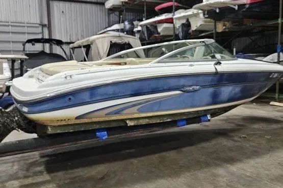 Slide: The Image of Sea Ray SRV 197 BR 2000 model boat in storage, blue and white exterior. - 4