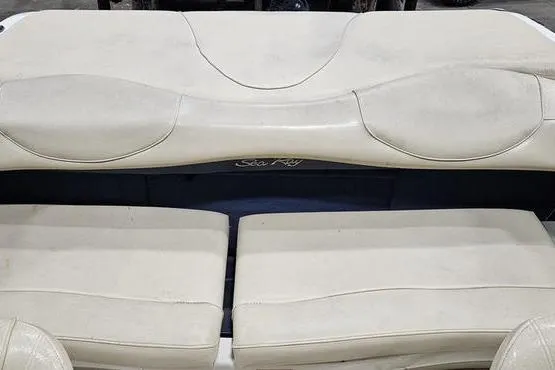Slide: The Image of 2000 Sea Ray SRV 197 BR boat interior with white cushioned seating. - 5