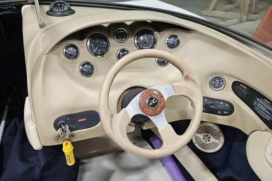 Slide: The Image of Interior dashboard of a 2000 Sea Ray SRV 197 BR boat with steering wheel and gauges. - 6