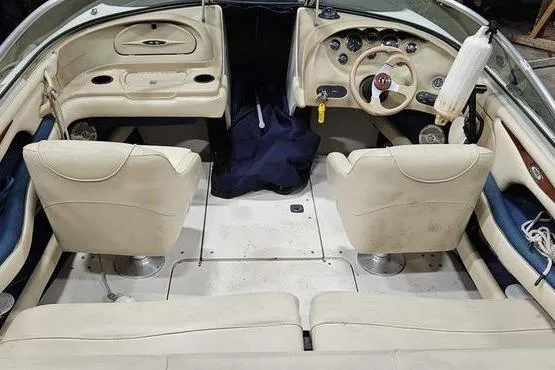 Slide: The Image of Interior of a 2000 Sea Ray SRV 197 BR boat with beige seating and dashboard. - 7