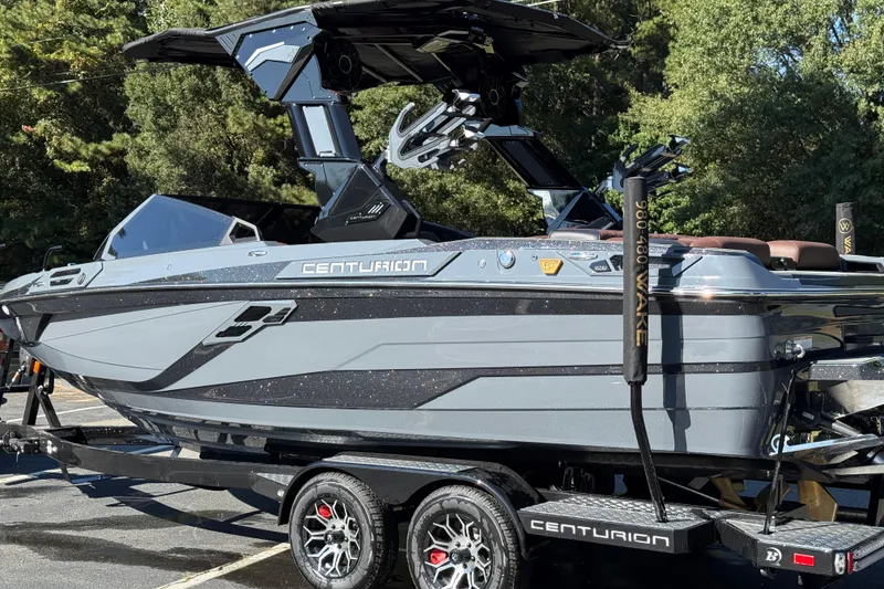 Slide: The Image of 2026 Centurion Ri230 boat on trailer, sleek design, parked outdoors. - 10
