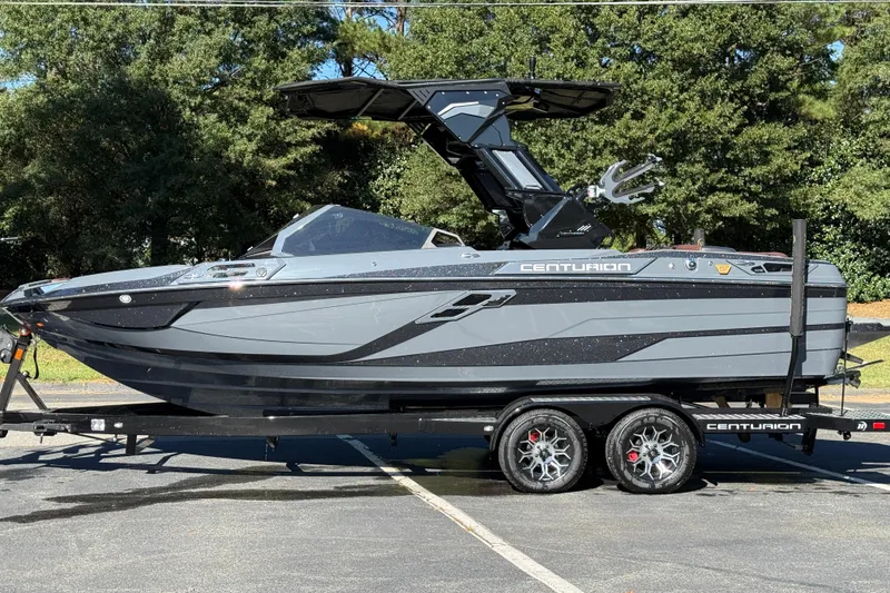 Slide: The Image of 2026 Centurion Ri230 boat on trailer, parked outdoors, side view. - 11
