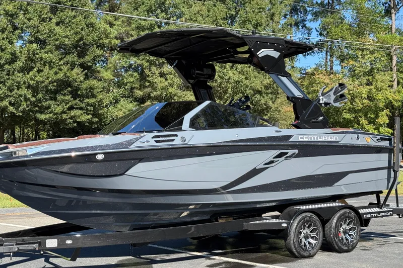 Slide: The Image of 2026 Centurion Ri230 boat on trailer, sleek design, parked outdoors. - 12