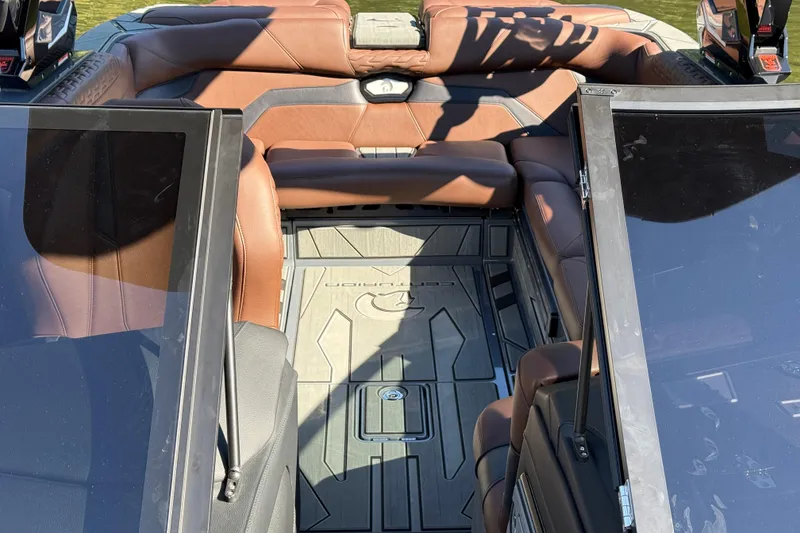 Slide: The Image of 2026 Centurion Ri230 boat interior with brown leather seating and sleek design. - 13