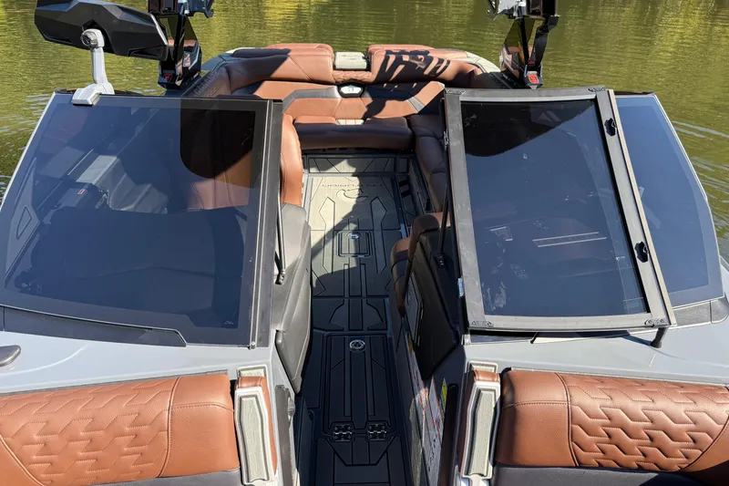Slide: The Image of 2026 Centurion Ri230 boat interior with brown leather seats and sleek design. - 14
