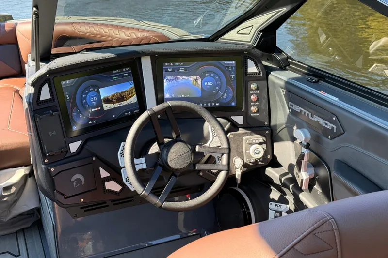 Slide: The Image of 2026 Centurion Ri230 boat dashboard with dual touchscreen displays and steering wheel. - 16