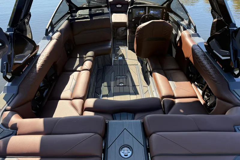 Slide: The Image of Luxurious interior of 2026 Centurion Ri230 boat with brown leather seating and modern dashboard. - 21