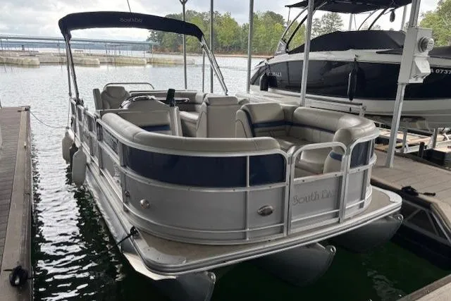 Slide: The Image of 2017 South Bay 222 RS pontoon boat docked on a calm lake. - 12