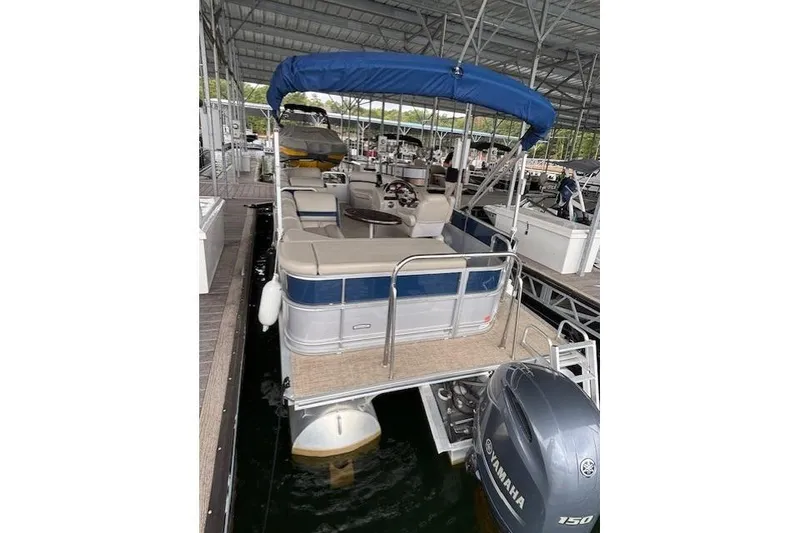 Slide: The Image of 2017 South Bay 222 RS pontoon boat with blue canopy docked in marina. - 15