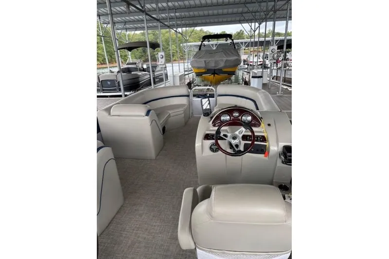 Slide: The Image of 2017 South Bay 222 RS pontoon boat interior with steering wheel and seating. - 16