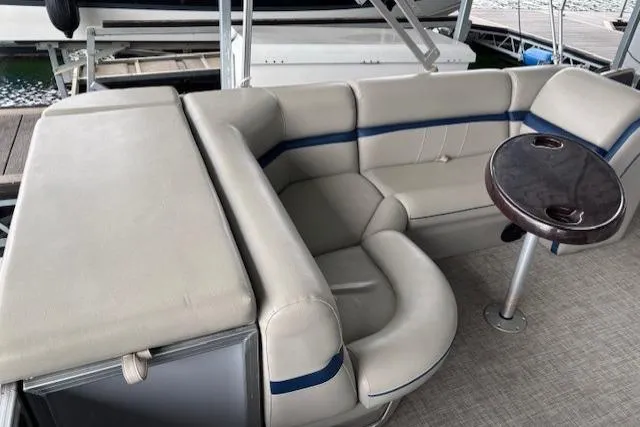 Slide: The Image of 2017 South Bay 222 RS boat interior with beige seating and small round table. - 17