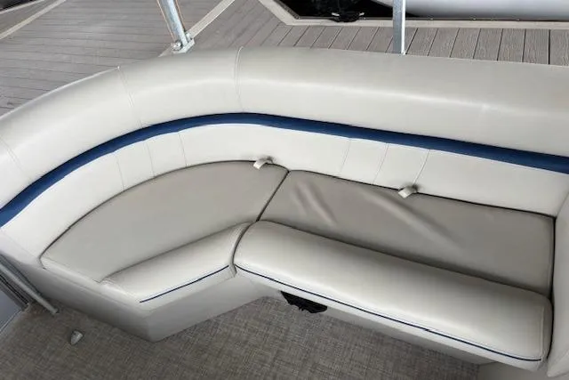 Slide: The Image of 2017 South Bay 222 RS boat interior with beige and blue cushioned seating. - 18