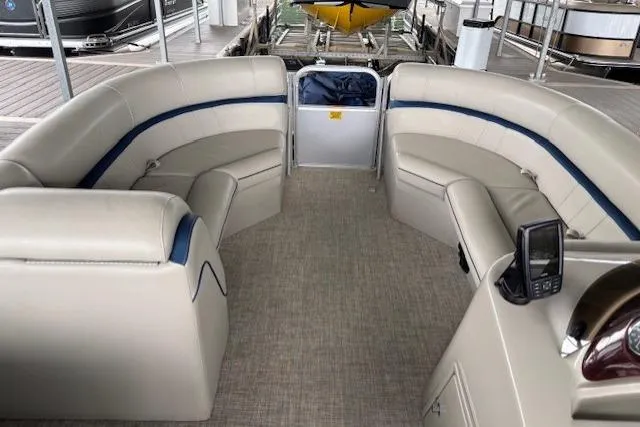 Slide: The Image of 2017 South Bay 222 RS pontoon boat interior with beige seating and modern dashboard. - 20