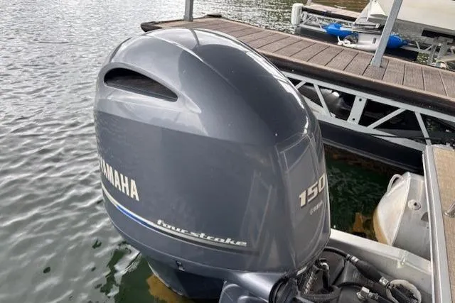 Slide: The Image of Outboard motor on 2017 South Bay 222 RS pontoon boat docked on water. - 24