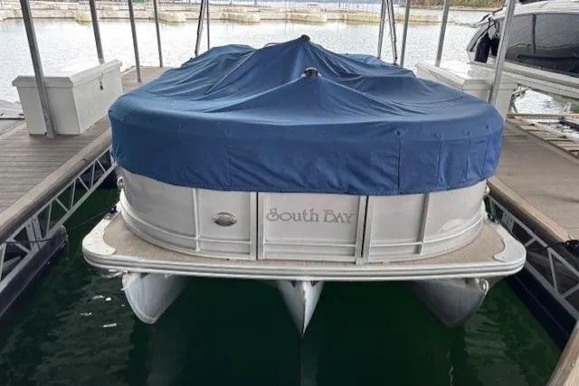 Slide: The Image of 2017 South Bay 222 RS pontoon boat with blue cover docked in marina. - 30