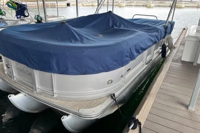 Slide: The Image of 2017 South Bay 222 RS pontoon boat docked with blue cover. - 31