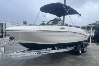 Slide: The Image of 2022 Bayliner VR6 Bowrider OB on trailer, featuring sleek design and canopy. - 2