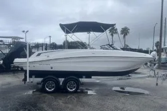 Slide: The Image of 2022 Bayliner VR6 Bowrider OB on trailer, parked outdoors under cloudy sky. - 3