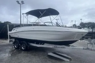 Slide: The Image of 2022 Bayliner VR6 Bowrider OB on trailer, parked outdoors under cloudy sky. - 4