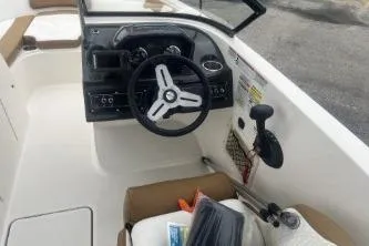 Slide: The Image of 2022 Bayliner VR6 Bowrider OB cockpit with steering wheel and controls. - 8