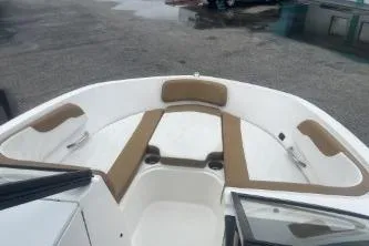 Slide: The Image of 2022 Bayliner VR6 Bowrider OB interior with tan seating and white deck. - 9
